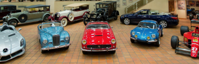 A vintage car collection including a Ferrari, Mercedes, and Renault Alpine.