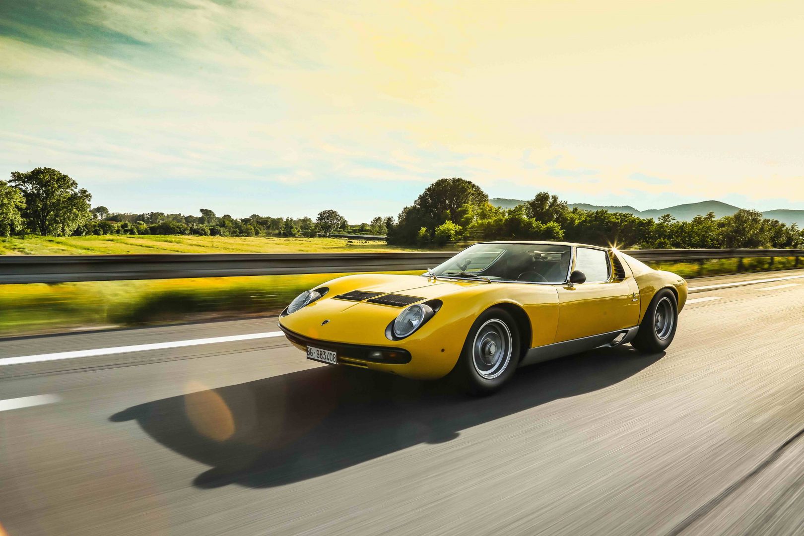 Yellow 1971 Lamborghini Miura SV Speeding on Highway