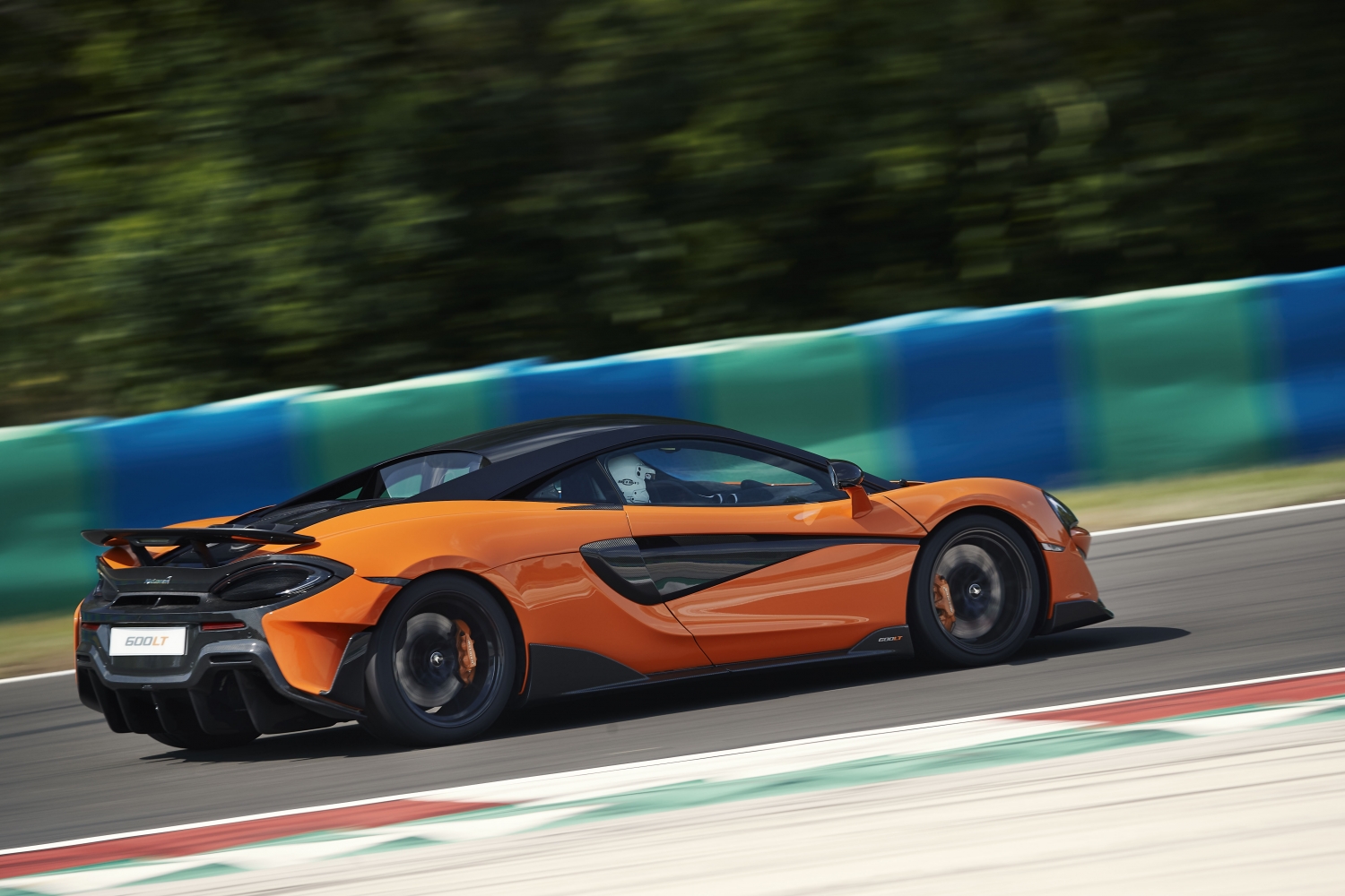 Model Perspective: McLaren 600LT Action Shot of McLaren Longtail Racing at High Speeds on Track. Track Life