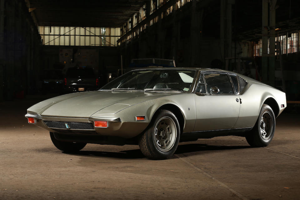 Brushed silver 1971 De Tomaso Pantera, in garage. Black leather interior. Classic Car Leasing is simple with Premier Financial.