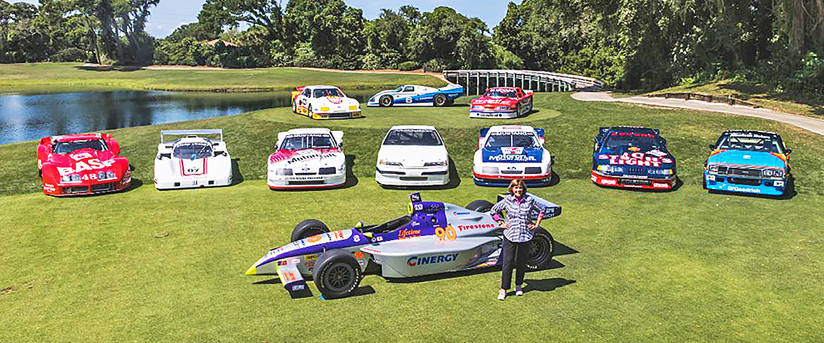 Lyn St. James and racecars at Amelia Island Concours. Classic Car Loans