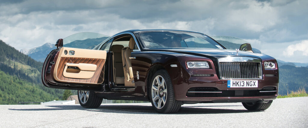 Rolls-Royce Wraith coach doors open against a mountiain skyline. Luxury Leasing.