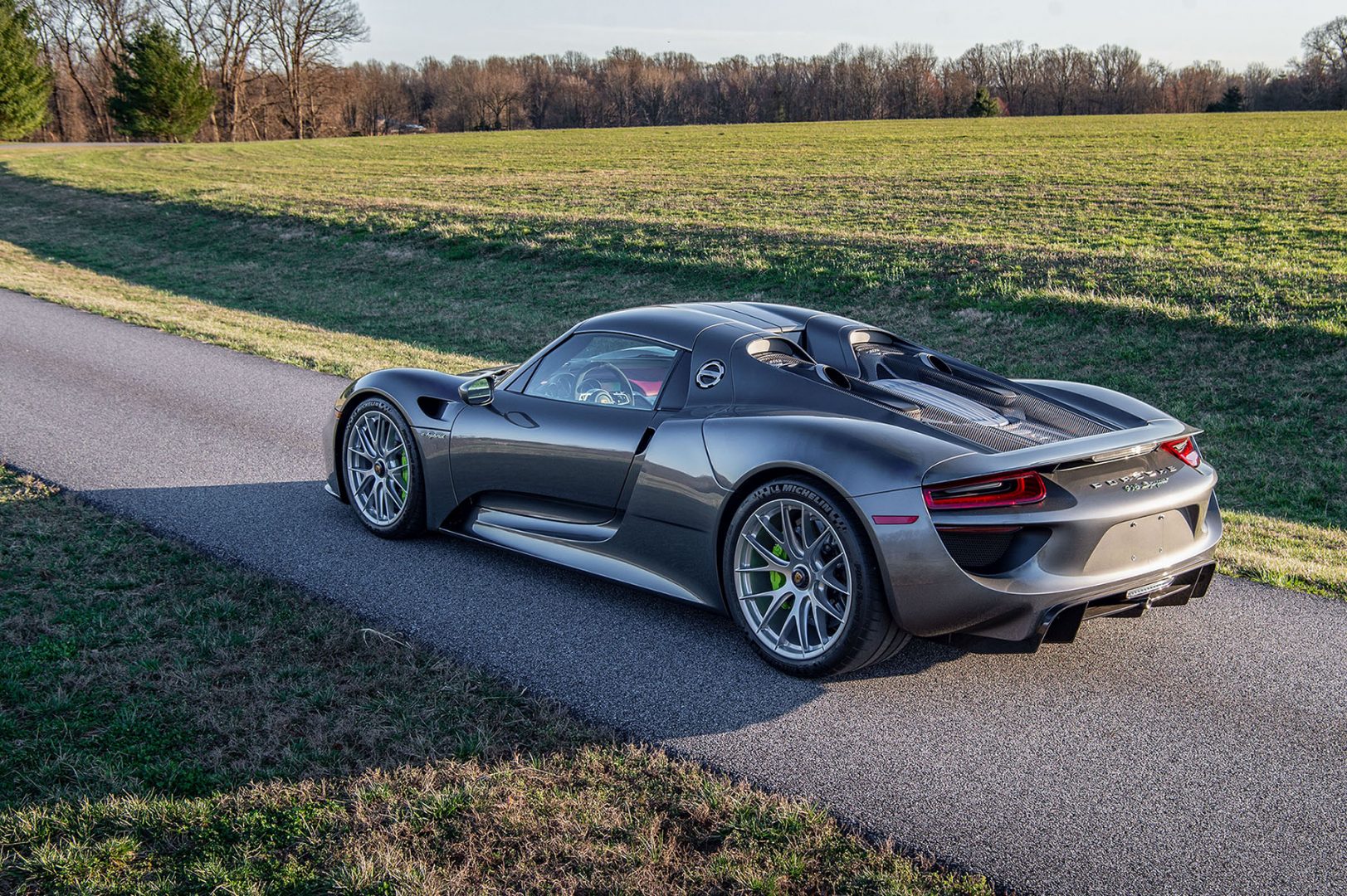 Silver Porsche 918 Spyder rear three-quarter view, view from above, green calipers; Perfect Porsche, PFS Simple Lease