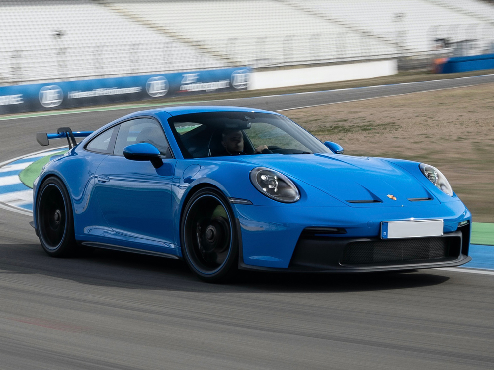 The new GT3 is ready for the track, but tame enough for the road. Blue 2022 Porsche 911 GT3 on track, front view