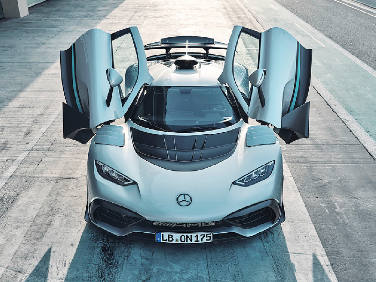 Silver Mercedes-AMG One on track, top front view, doors open