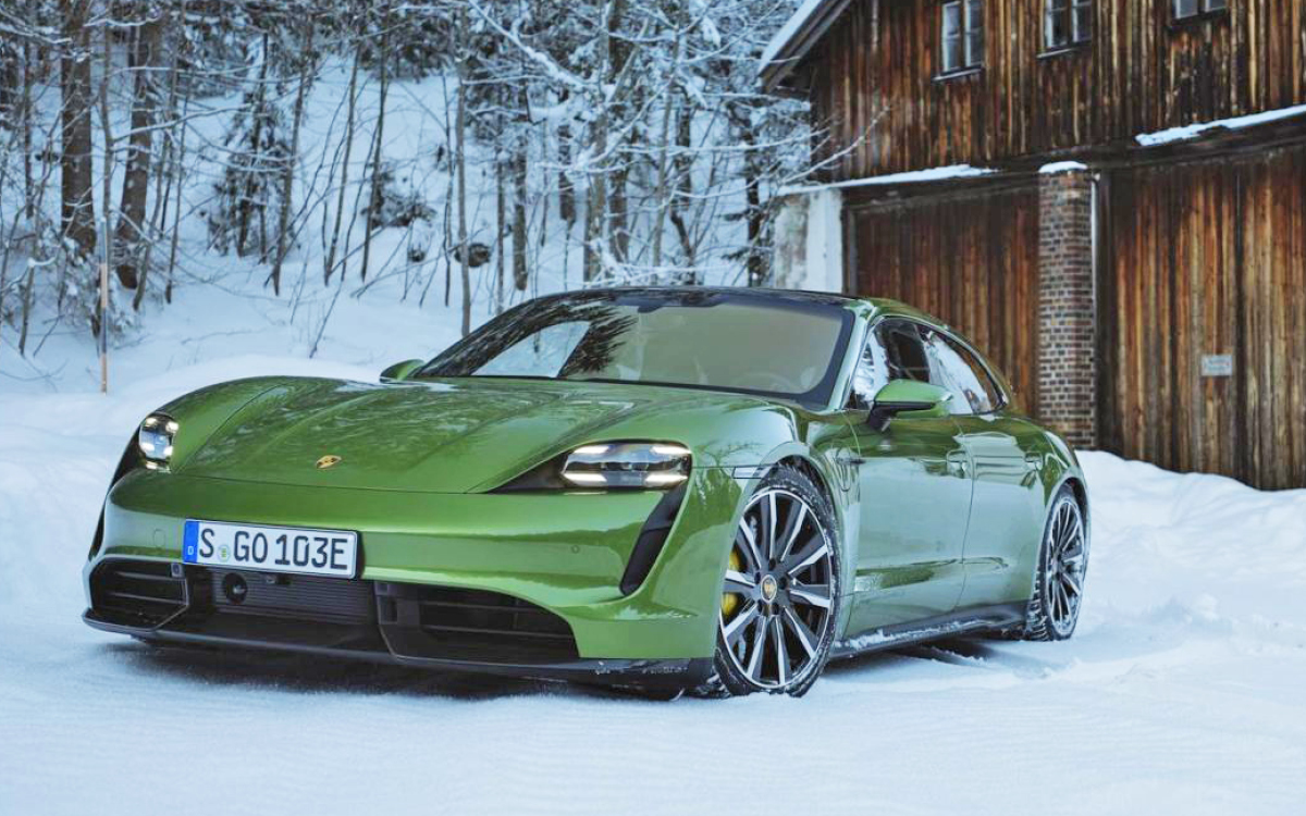 Green Porsche Taycan in snow