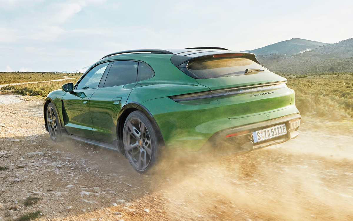 Green Porsche Taycan on snow-covered road