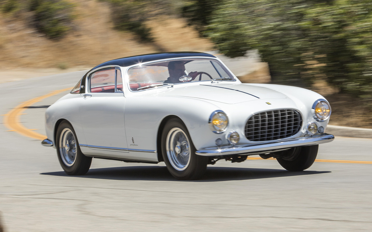 White Ferrari 250 Europa GT driving on road