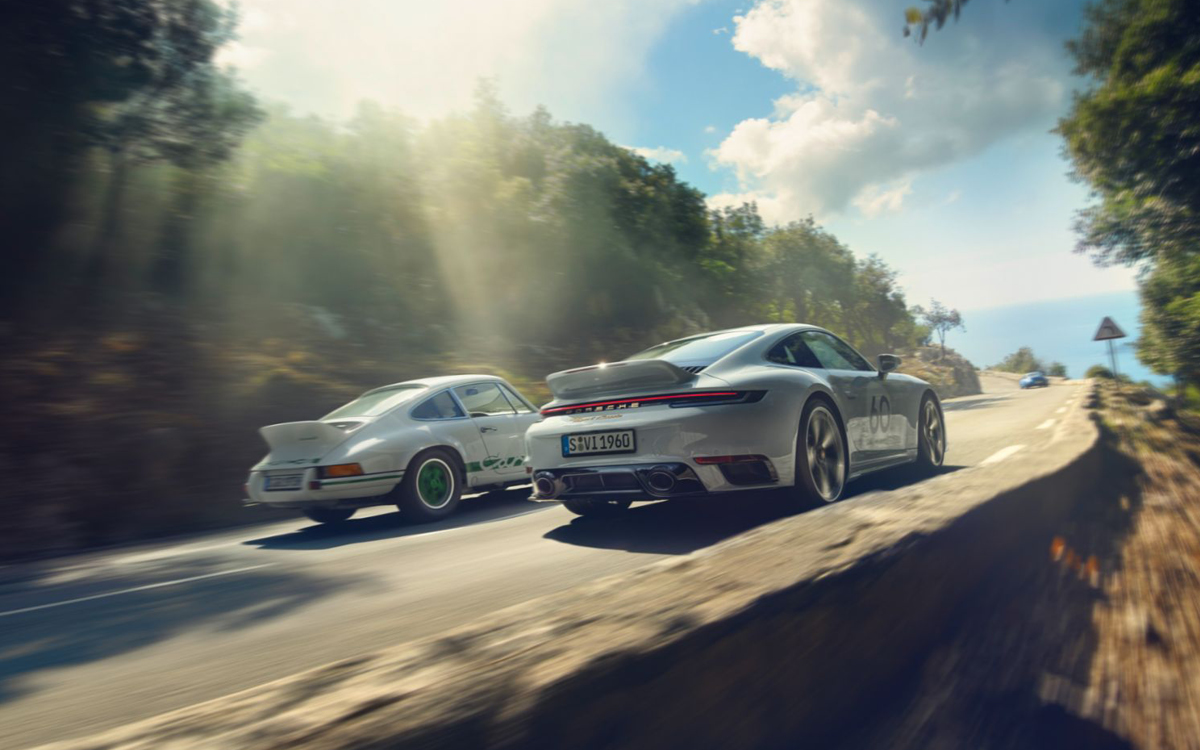 2023 Porsche 911 Sport Classic and 1973 Carrera 2.7 RS, rear shot on road