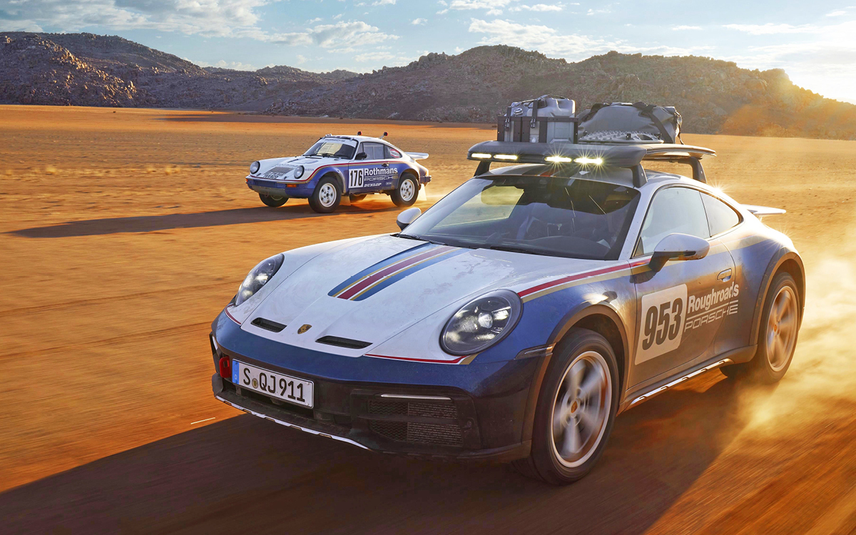 Blue and white 2023 Porsche 911 Dakar with 1984 Porsche 953 rally car