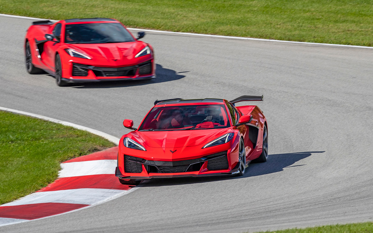 Two red Corvette Z06 models on a racetrack
