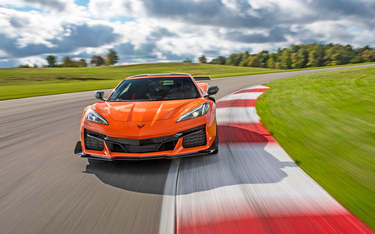 Orange 2023 Corvette Z06 on racetrack, front view