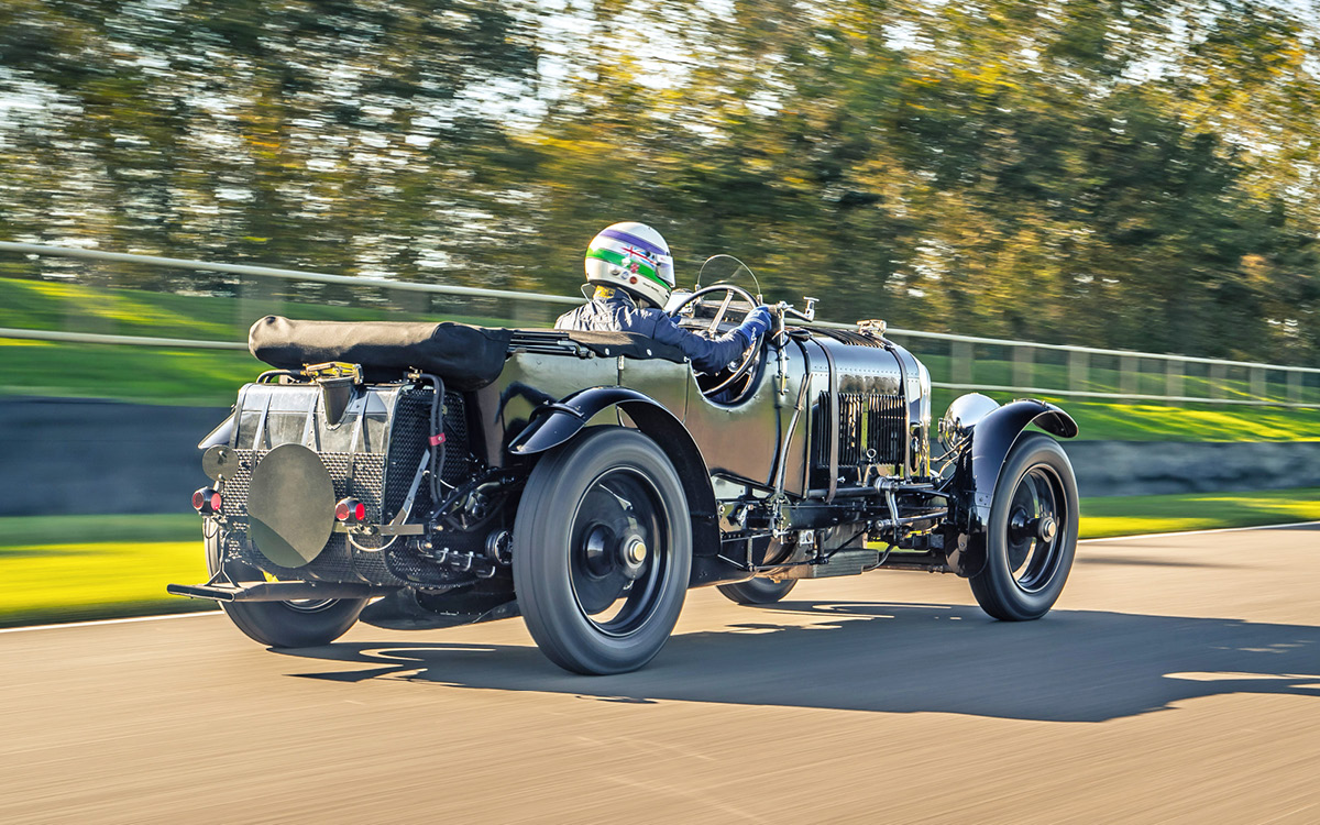 Green Bentley Blower Continuation Series Car Zero on racetrack, rear right side view