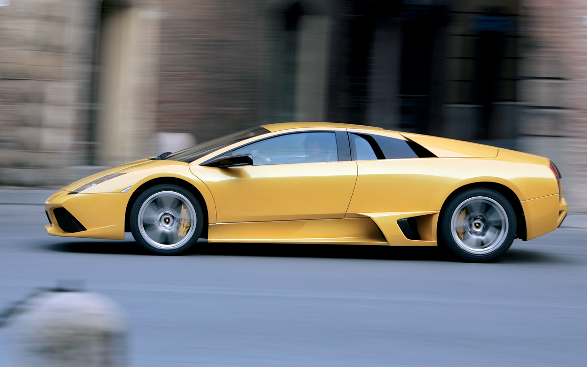 Yellow Lamborghini Murciélago on road, left side view