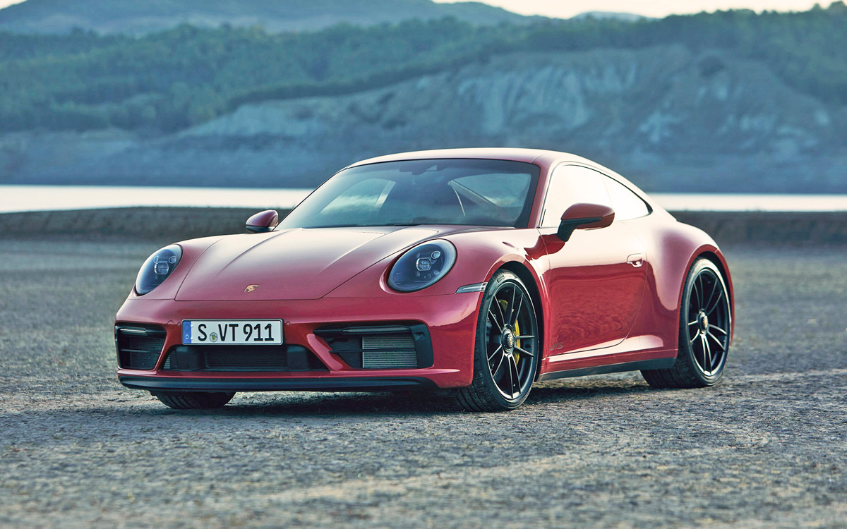 Red Porsche 911 GTS in desert setting, left front view