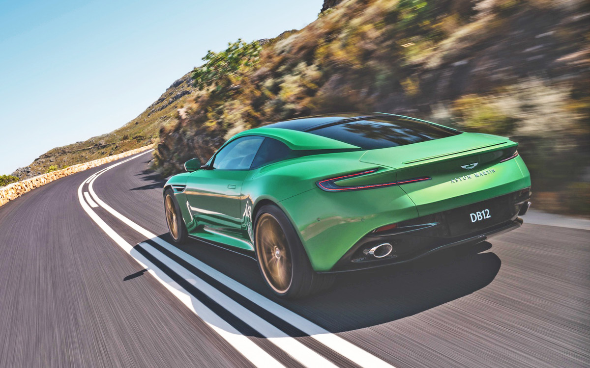 Green Aston Martin DB12 on road, rear view