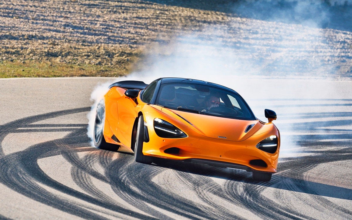 Orange McLaren 750S on track, front view