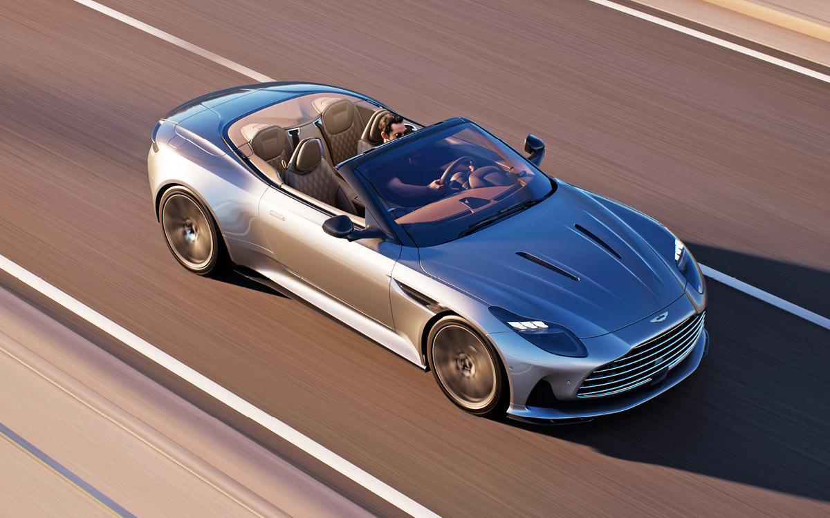 Silver 2024 Aston Martin DB12 Volante on road, top down