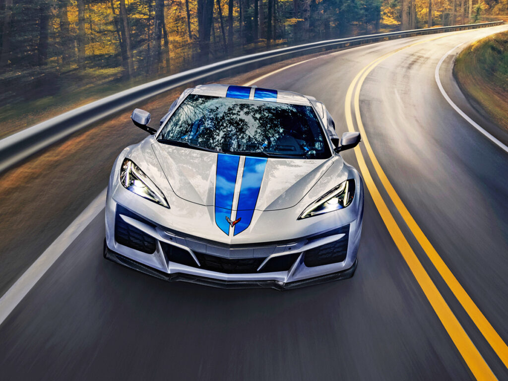 Silver Corvette E-Ray on country road, top front view.