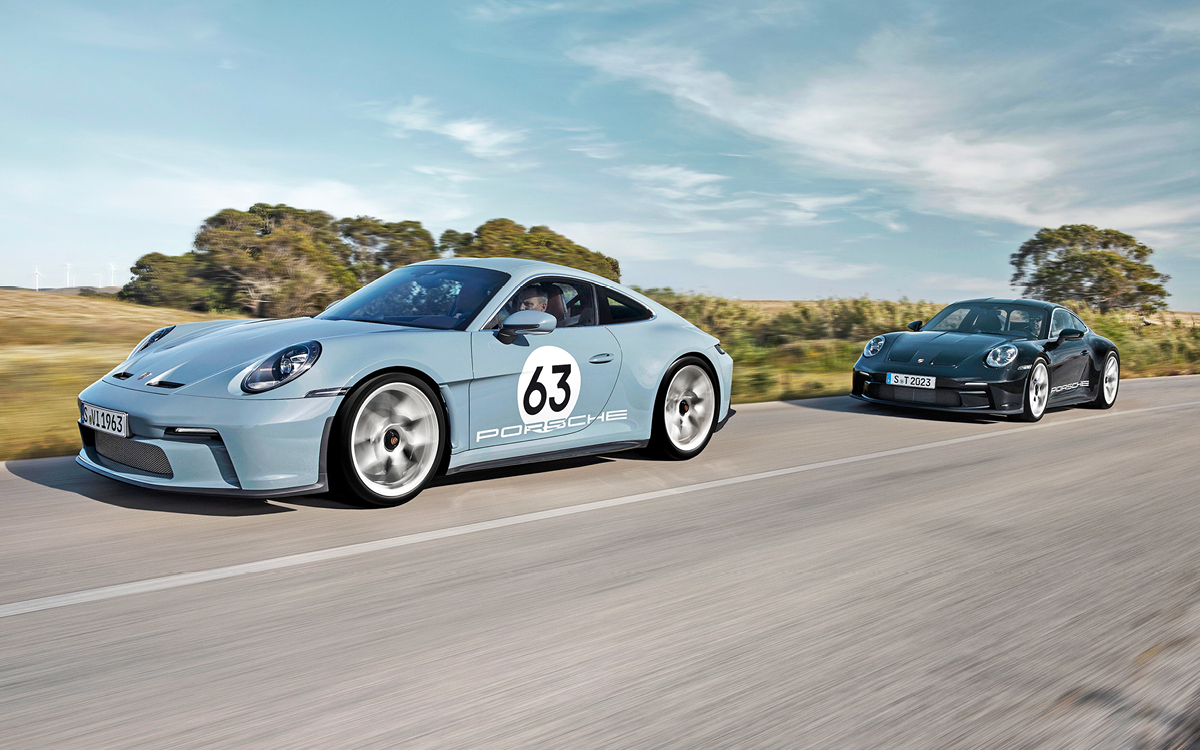 Shore Blue Metallic Porsche 911 S/T and black 911 S/T on road.