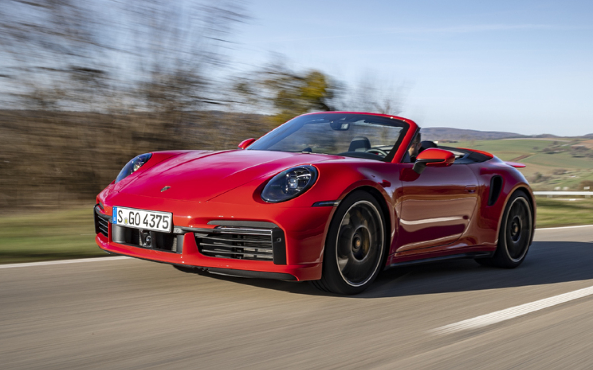 Red Porsche 911 Turbo S convertible on road