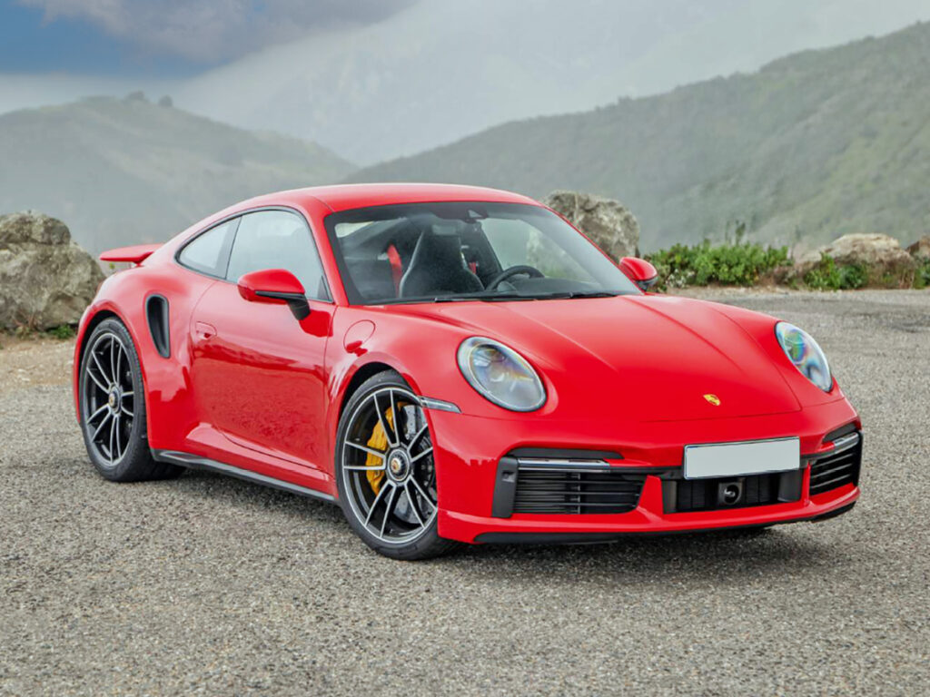 Red Porsche 911 Turbo S coupe in mountain setting