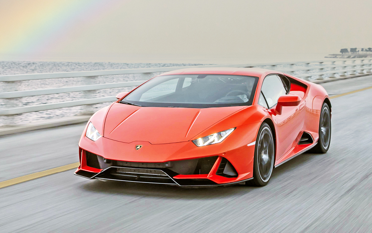 Orange Lamborghini Huracan on ocean road