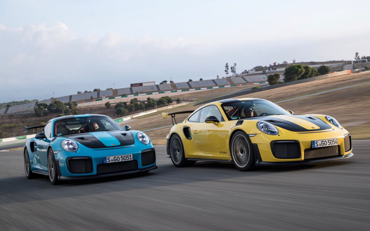 Blue and yellow Porsche 911 GT2 RS models on racetrack