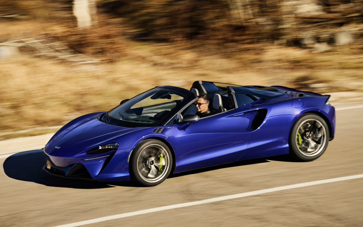 Blue McLaren Artura Spider on road side view