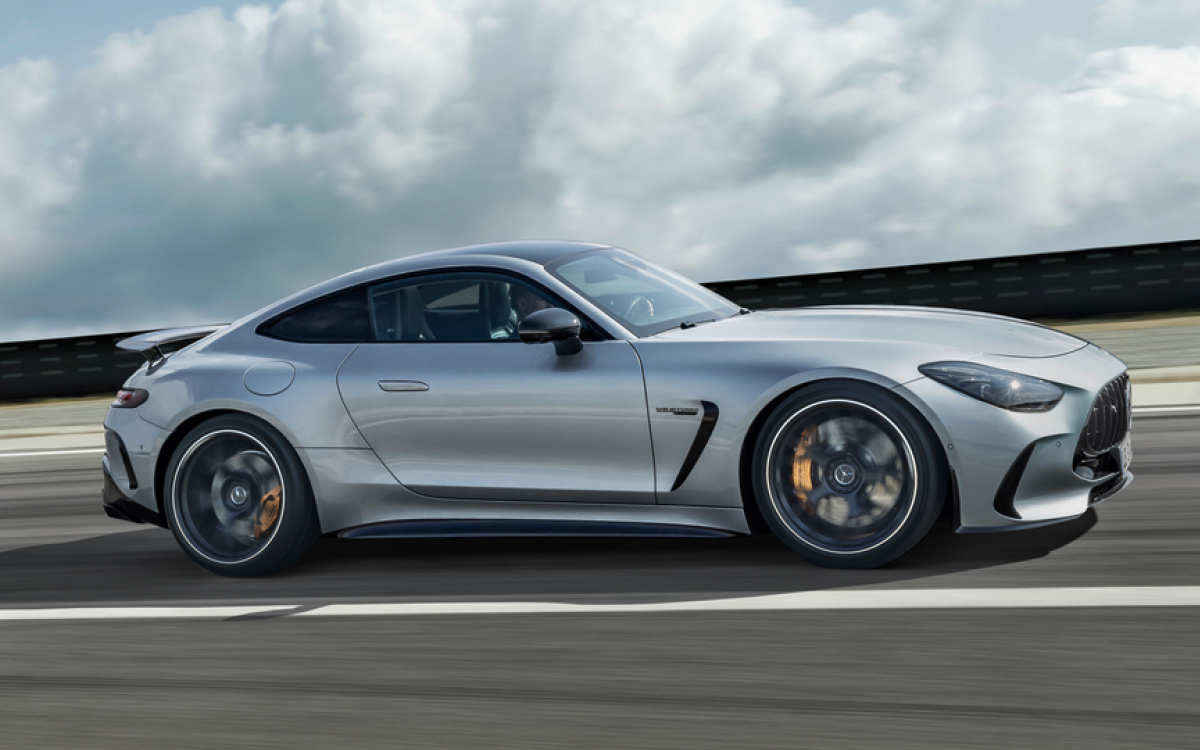 Silver 2024 AMG GT on the road, side view