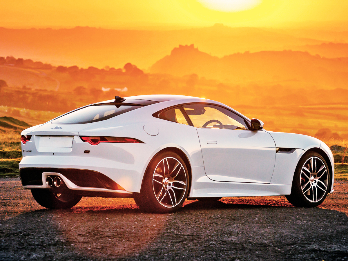 White Jaguar F-Type coupe right rear view