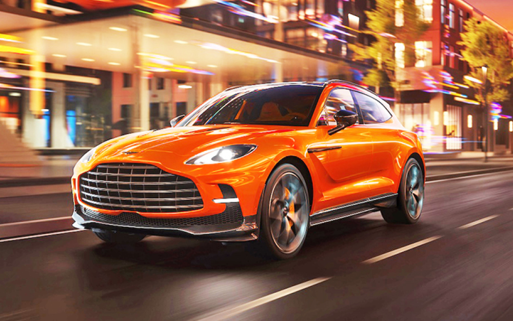 Orange Aston Martin DBX 707 in city