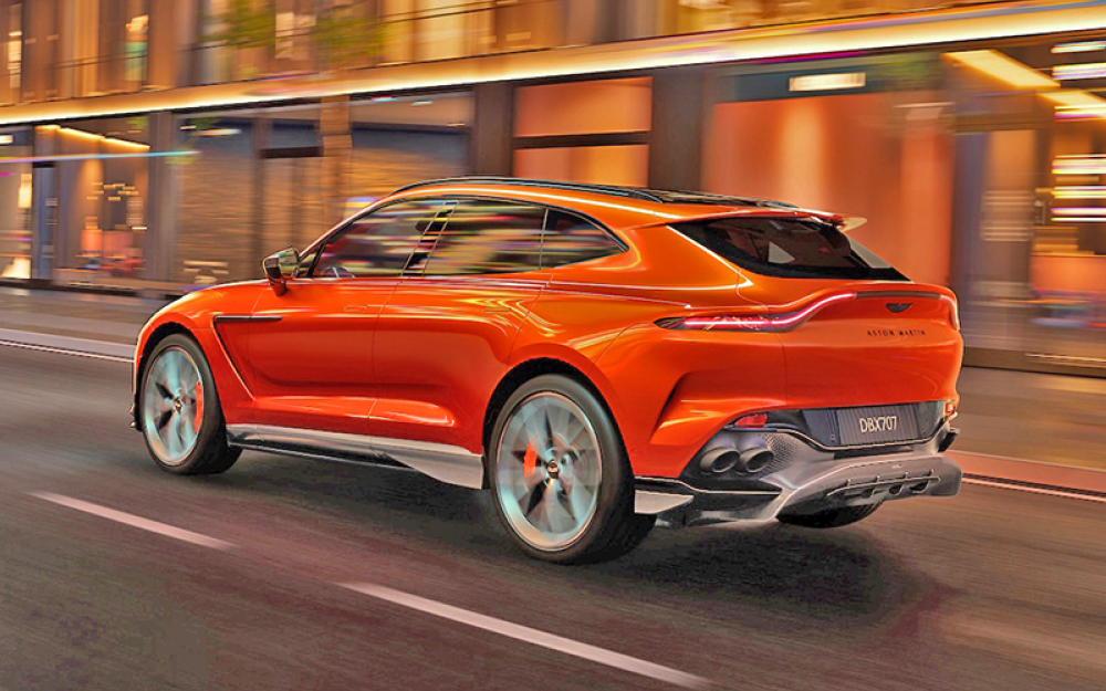 Orange Aston Martin DBX 707 in city, rear view