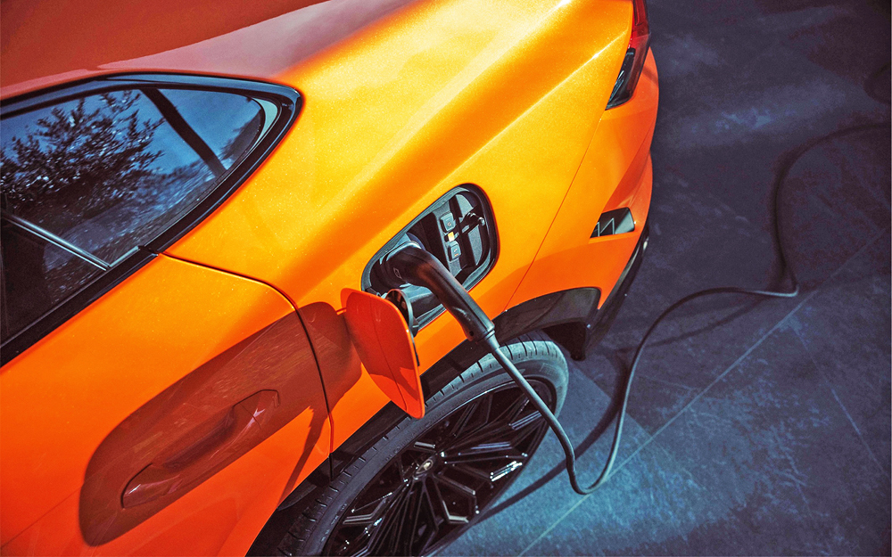 Orange Lamborghini Urus SE electric charge port
