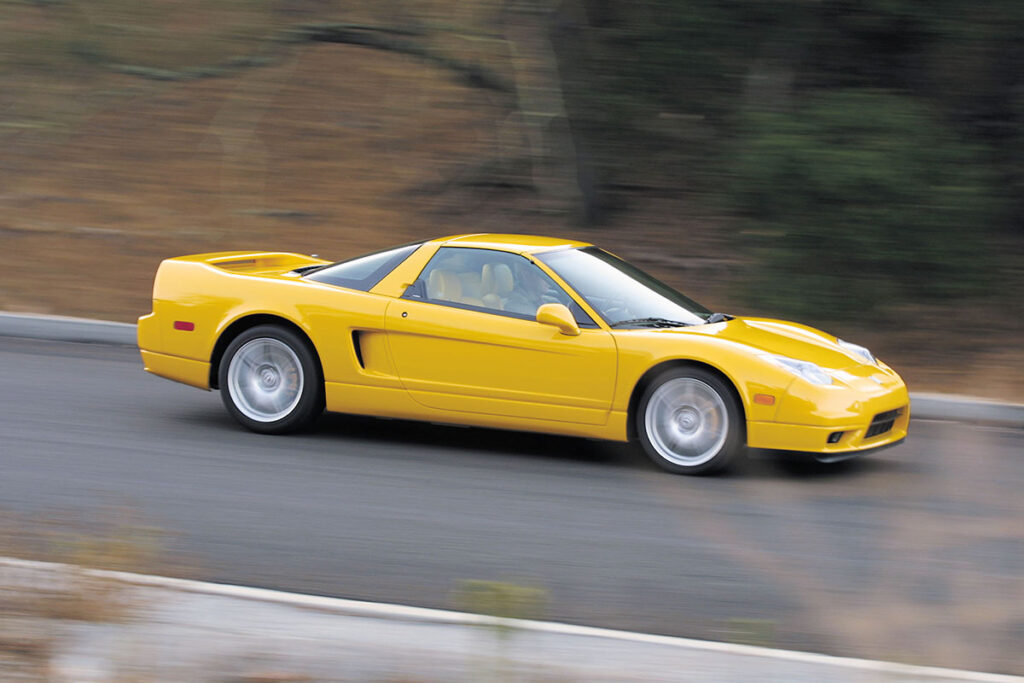 Yellow Acura NSX on road